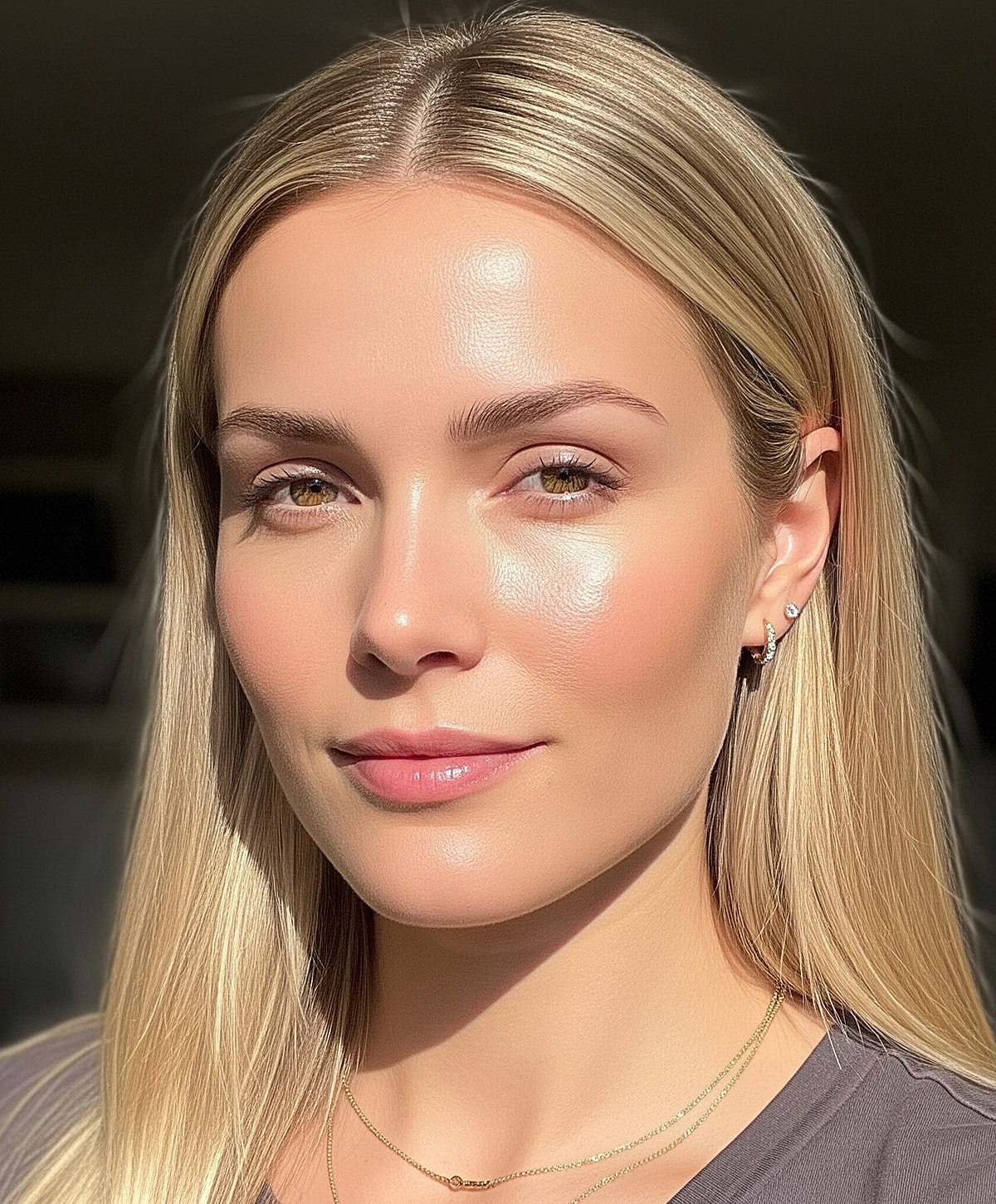 Woman with blonde hair and natural makeup.