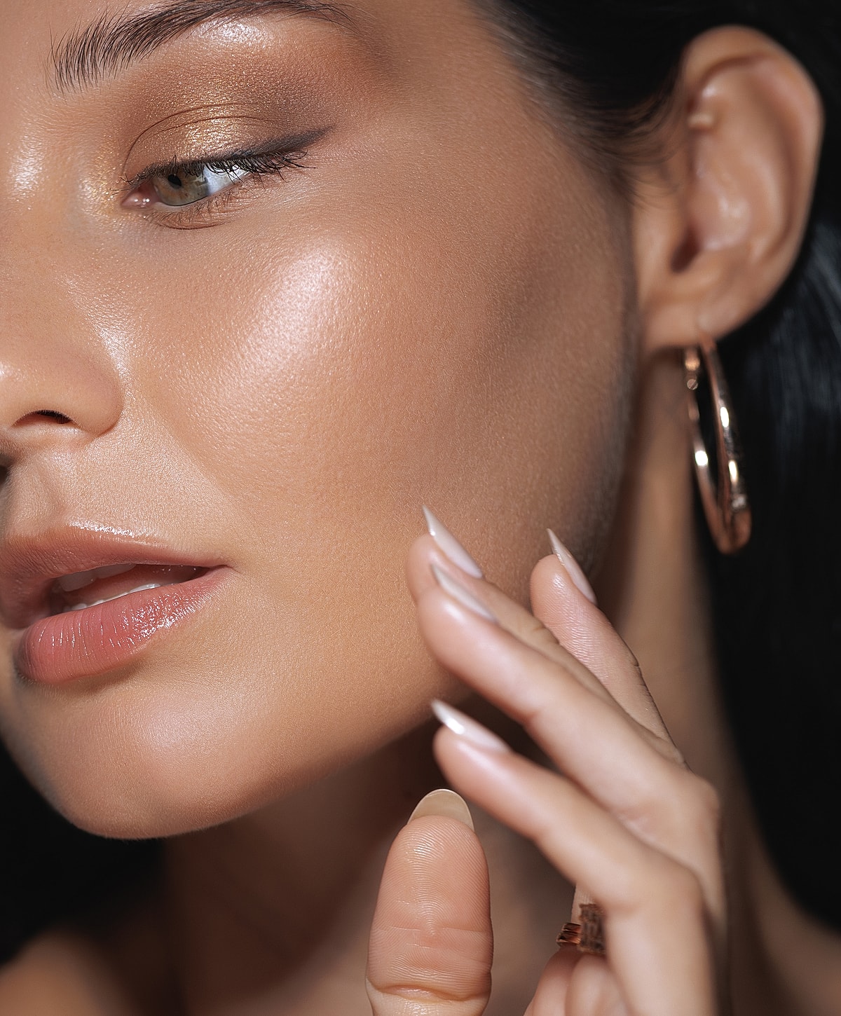 Close-up of woman’s face highlighting makeup and skin.