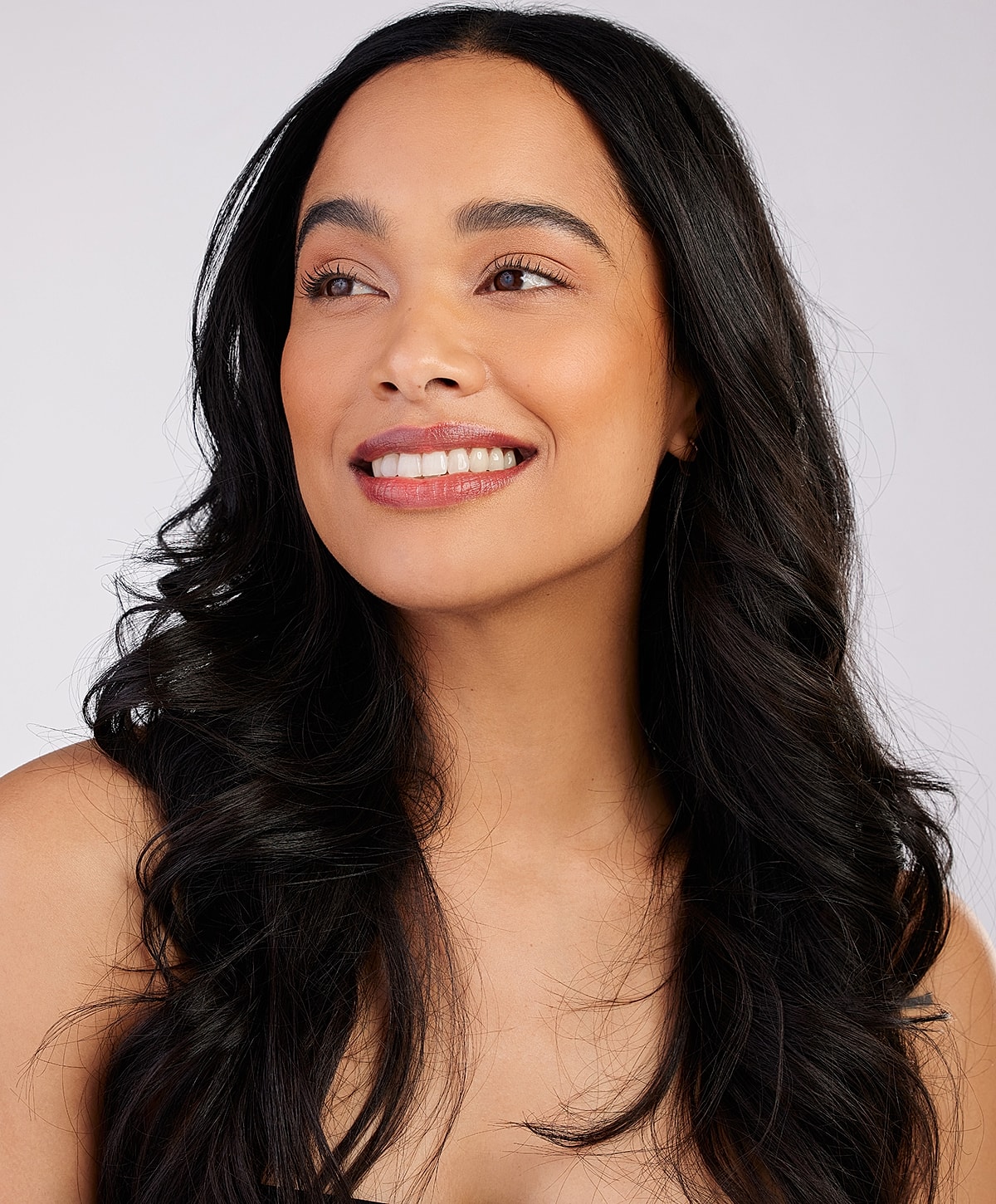 Smiling woman with long, flowing dark hair