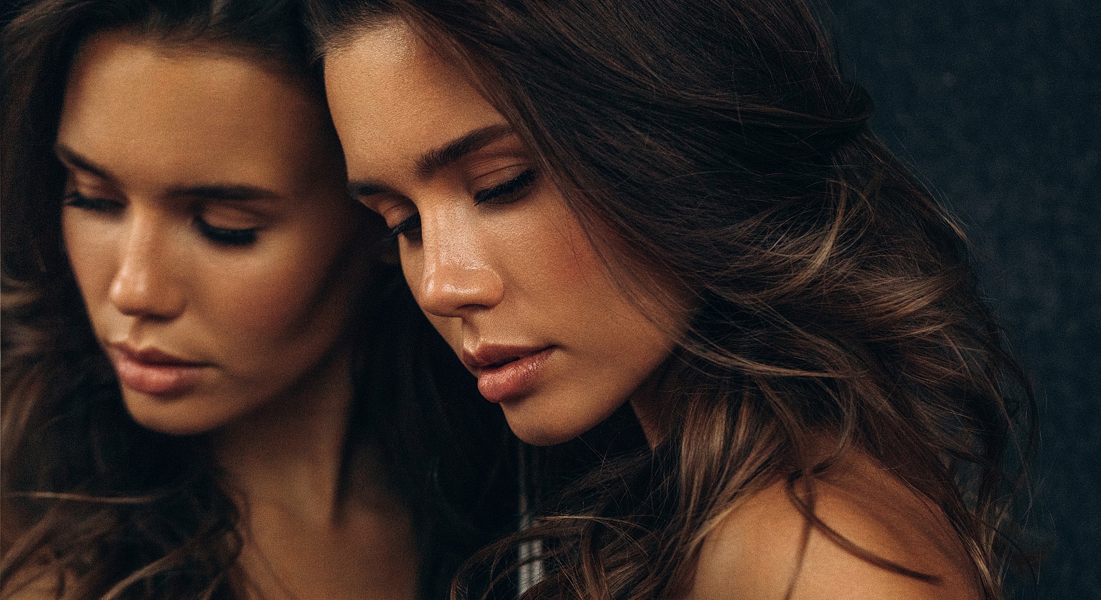 Woman with flowing hair and serene expression.
